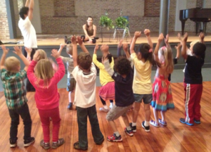 Spanish gym class TMCS students stretch and move, following instructions given in Spanish