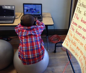 strengthening his core on a balance ball while honing his core curriculum skills