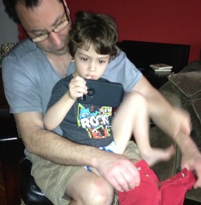 This child is so immersed in the iPhone screen that he can't even participate in getting dressed for school. Hope he's learning something!