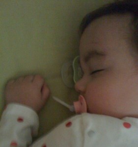 We all have our sleep triggers. This baby girl gets to sleep with--and on--a pacifier.