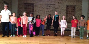 The class lines up to take a group bow after their hard work during rehearsal. Well done kids!